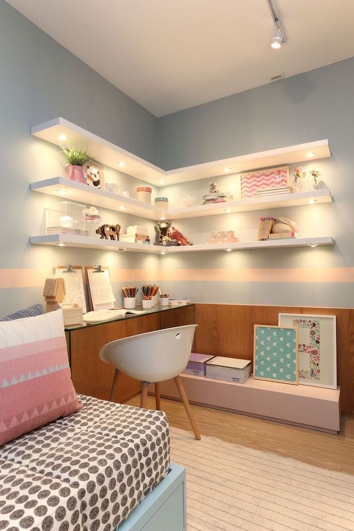 Bookshelves-with-led-lights-on-light-blue-wall-above-desk-teenage-girl-bedroom-ideas-wooden-floor-pink-throw-pillows-on-the-bed-1