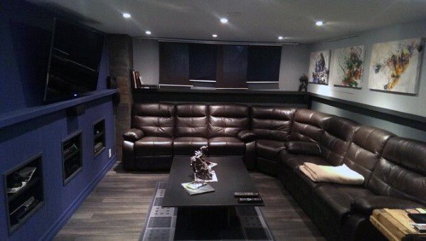 Brown-leather-sectional-with-navy-wall-basement-man-cave