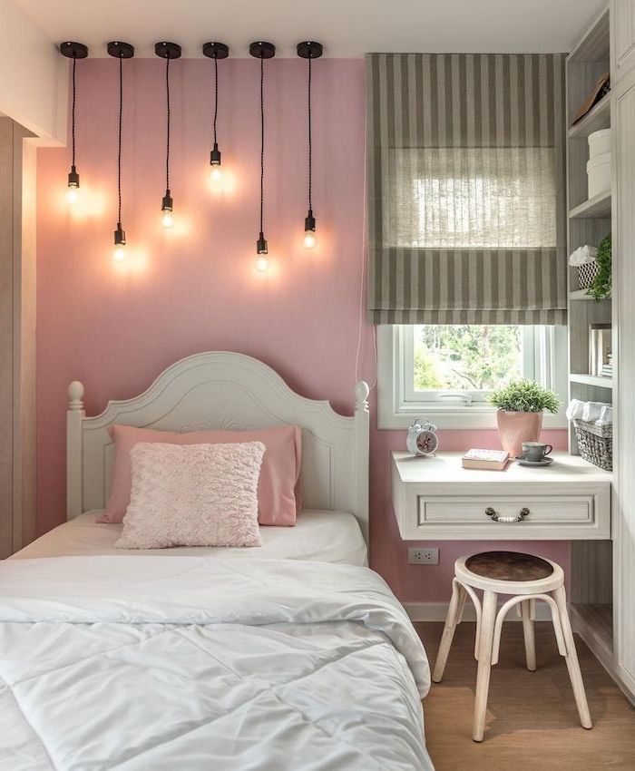 Floating-desk-next-to-the-bed-teenage-girl-bedroom-ideas-for-small-rooms-pink-wall-with-hanging-lamps-with-different-length-above-the-bed