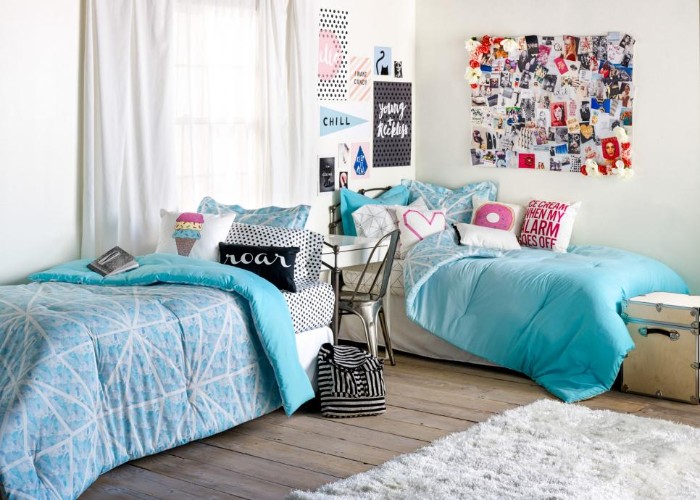 Room-for-sisters-with-a-wooden-floor-and-a-fluffy-pale-grey-rug-two-beds-with-blue-covers-ideas-for-teen-bedrooms-white-walls-with-posters-and-a-board-with-photos