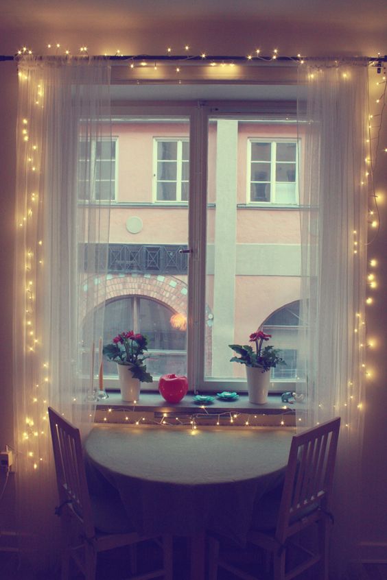 08-a-little-breakfast-nook-becomes-inviting-with-sheer-curtains-and-string-lights-inside-them