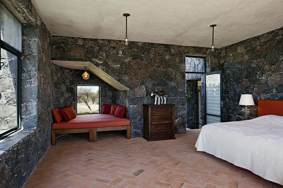 1-mediterranean-bedroom-showcases-terracotta-tiles-and-dark-stone-walls