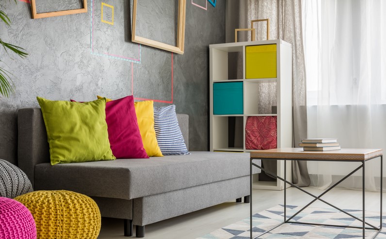 Grey couch with colored cushion