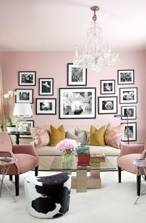 A-chic-pink-living-room-with-light-pink-chairs-a-black-and-white-gallery-wall-and-colorful-pillows