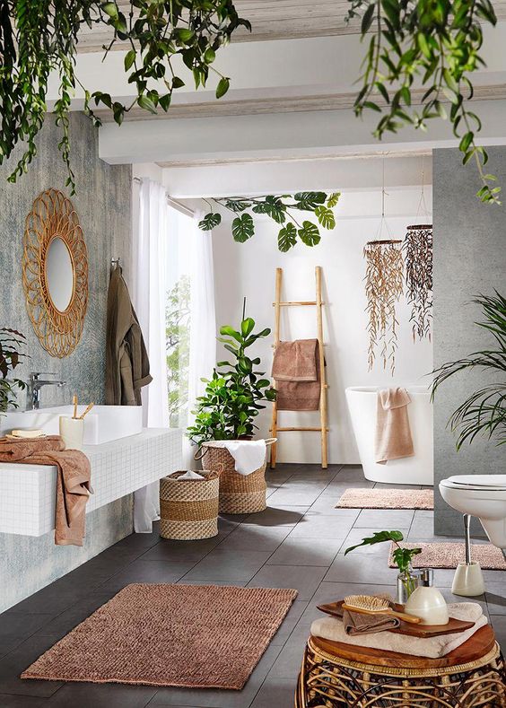 A-contemporary-meets-boho-space-with-potted-greenery-baskets-rattan-furniture-a-wicker-mirror-and-a-ladder