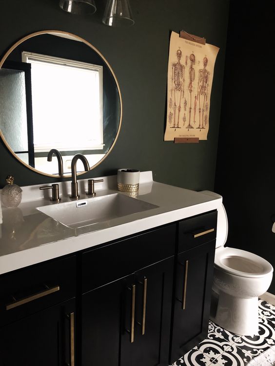 A-stylish-and-moody-bathroom-with-matte-black-walls-a-black-vanity-a-white-stone-countertop-and-catchy-artworks