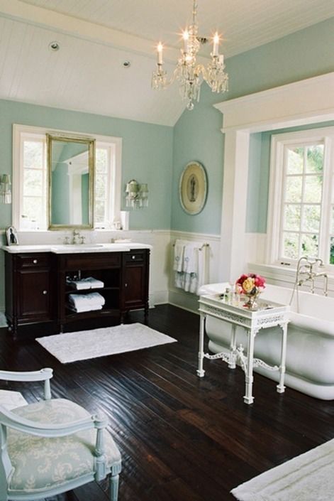 09-a-dark-stained-floor-and-a-matching-vanity-are-of-a-dominant-dark-tone-and-the-rest-of-the-furniture-is-whitewashed