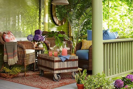 1-a-tropical-boho-porch-with-woven-furniture-a-wooden-coffee-table-potted-greenery-and-colorful-textiles