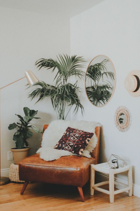 2-02-a-boho-nook-with-a-leather-chair-some-potted-greenery-a-mirror-and-a-lamp-makes-up-a-cozy-reading-space