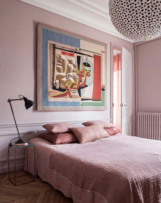 2-04-a-chic-bedroom-with-light-pink-walls-pink-bedding-and-a-statement-artwork-and-a-polka-dot-lamp-1