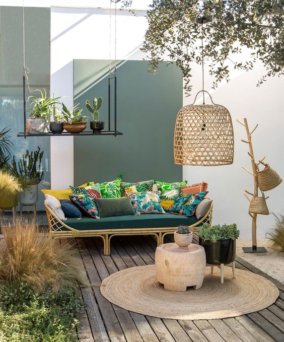 2-25-a-welcoming-tropical-terrace-with-a-rttan-sofa-colorful-pillows-a-jute-rug-wicker-baskets-and-a-wicker-lampshade-plus-potted-plants