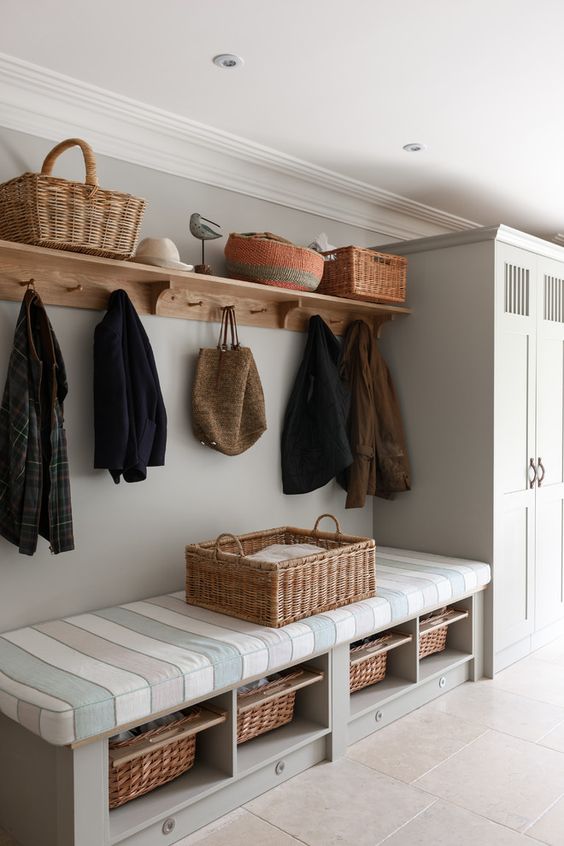 20-a-bench-with-a-striped-mattress-on-top-and-some-woven-baskets-as-drawers-inside
