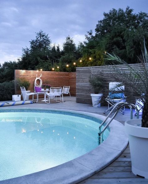 5-a-welcoming-contemporary-space-with-metal-furniture-and-a-large-round-pool-with-inner-lights-looks-inviting
