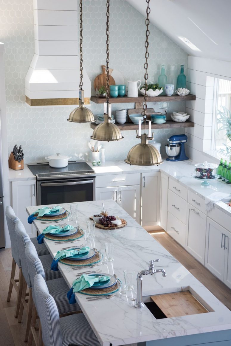 A-charming-coastal-kitchen-with-white-cabients-an-aqua-scale-tile-backsplash-a-marble-kitchen-island-and-blue-striped-chairs-775x1161-1