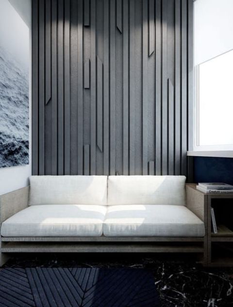 A-textural-accent-wall-done-with-wooden-slabs-attach-to-a-plywood-sheet-and-painted-in-an-elegant-grey-shade