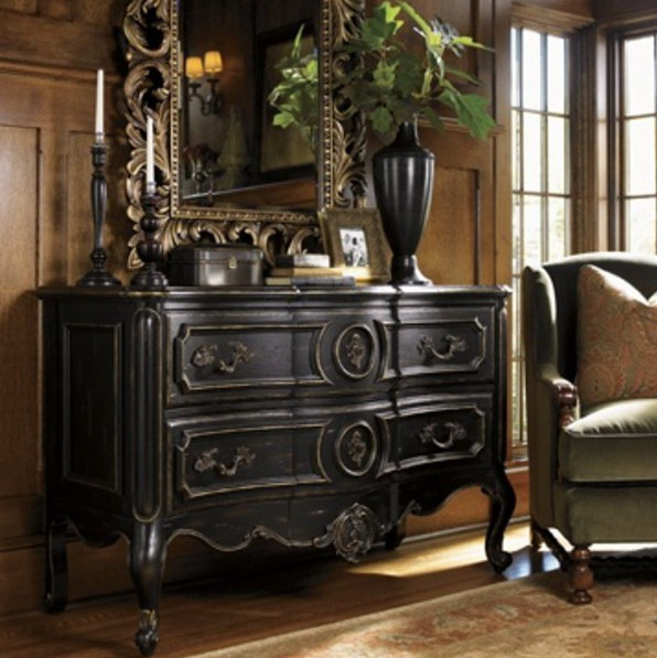 05-a-dark-wood-sideboard-with-antique-decor-a-mirror-and-a-dark-vase