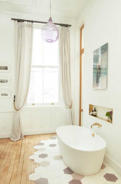 1-20-a-neutral-bathroom-with-wooden-fllors-and-hexagon-tiles-in-various-colors-under-the-bathtub