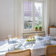 1495675320-dining-room-table-windows-natural-light
