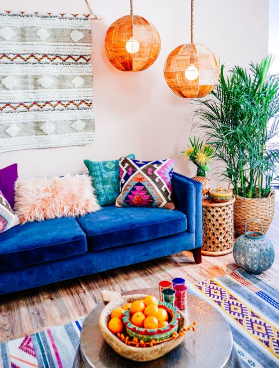 2-a-colorful-boho-living-room-with-a-boho-hanging-faceted-lamps-a-blue-sofa-colorful-pillows-and-a-rug
