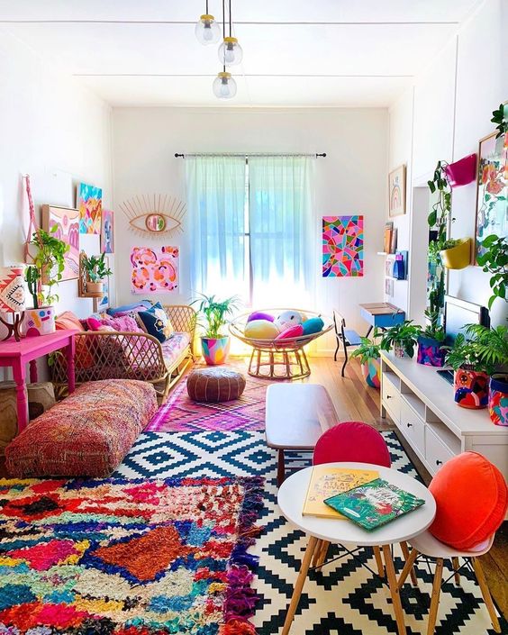 2-a-colorful-boho-living-room-with-a-bright-gallery-wlal-colorful-rugs-and-pillows-potted-greenery-and-florals-is-summer-like