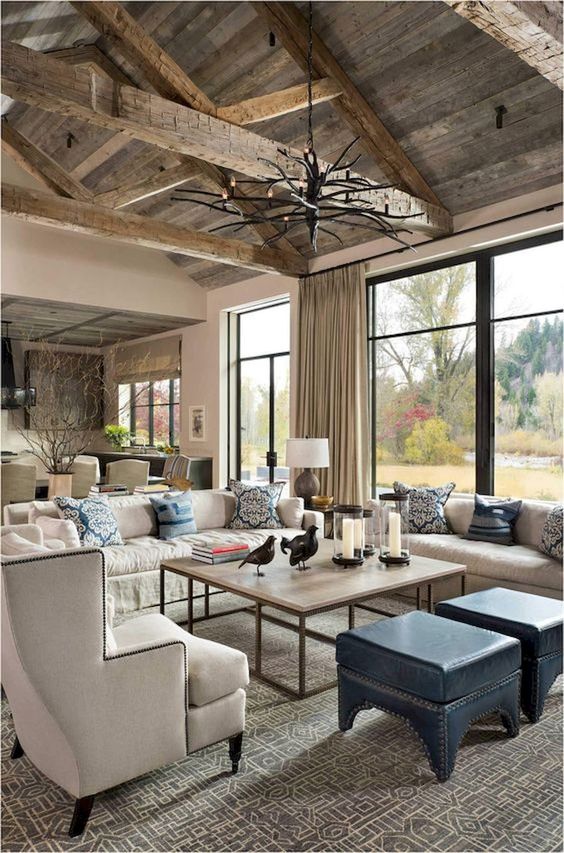 2-a-rustic-farmhouse-living-room-with-much-light-colored-woodcremay-furniture-a-branch-chandelier-and-printed-pillows