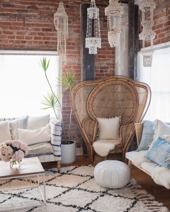 4-06-an-oversized-peacock-chair-with-extended-sides-faux-fur-a-white-pompom-pillow-for-a-boho-living-room