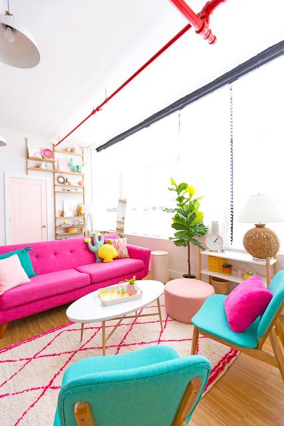 A-colorful-living-room-with-a-pink-sofa-turquoise-chairs-bright-pillows-of-catchy-shapes-for-fun