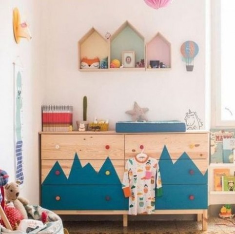 A-double-tarva-dresser-with-a-mountain-inspired-pattern-and-colorful-knobs-for-an-adventure-themed-kids-room