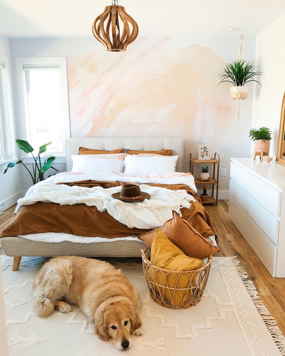 A-small-modern-bedroom-with-a-watercolor-wall-a-sleek-white-dresser-an-upholstered-bed-and-a-wooden-lamp-potted-plants