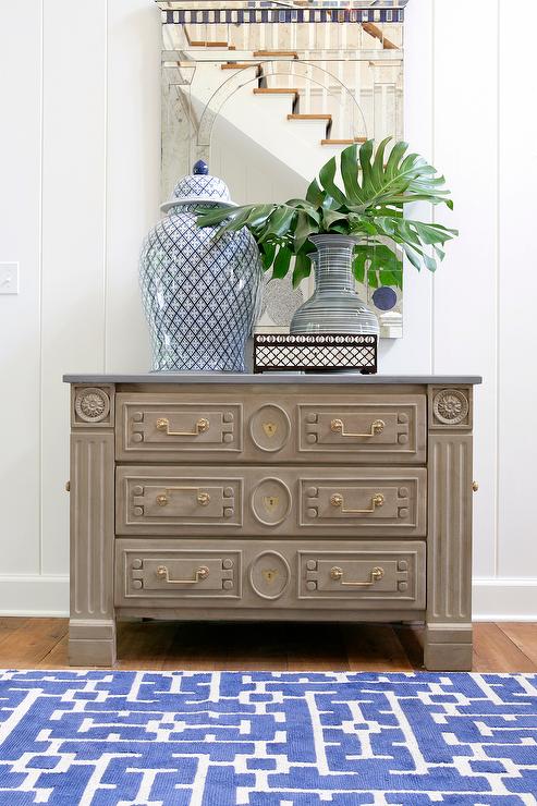 Blue-and-grey-foyer-gray-chest-antiqued-mirror-blue-geometric-rug