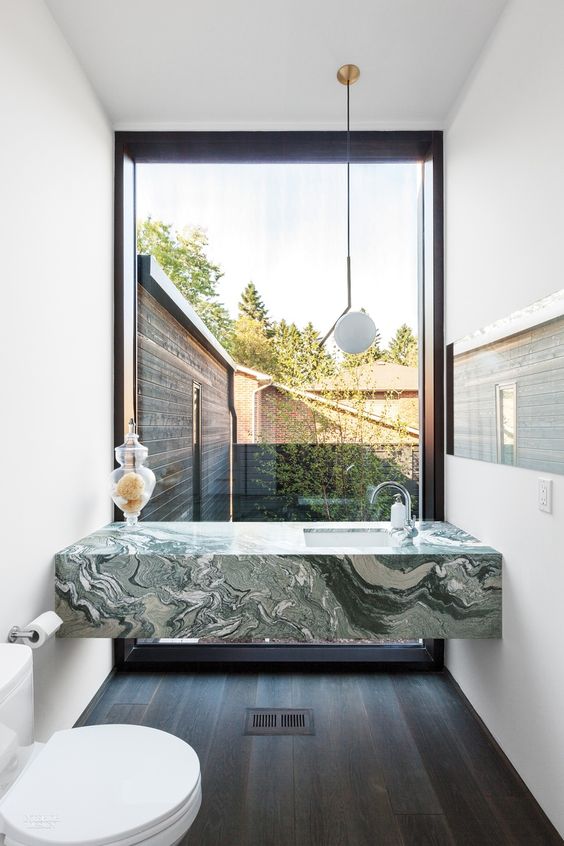 04-a-green-marble-modern-vanity-in-a-small-powder-room-with-a-view-to-the-courtyard