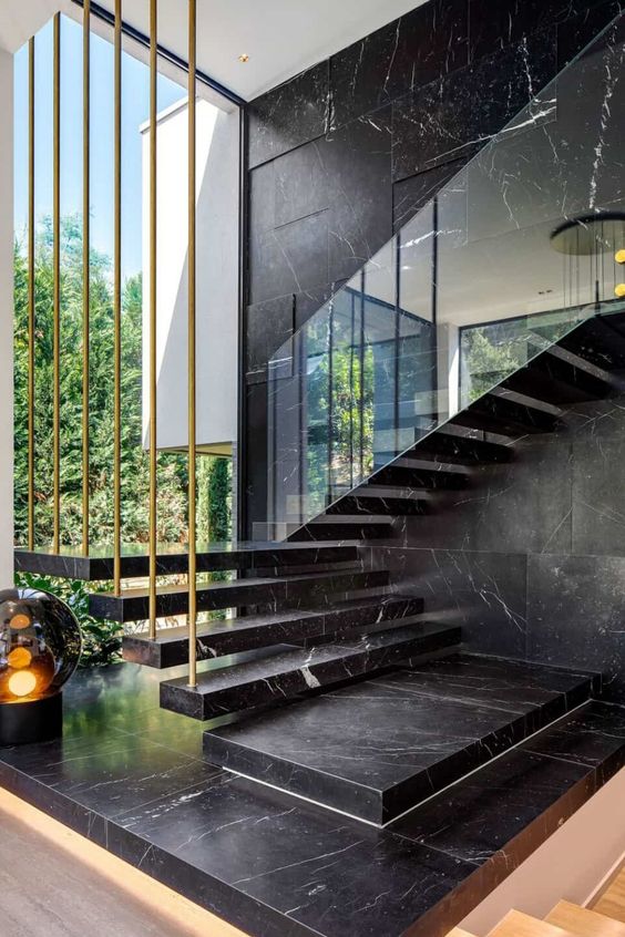 1-19-a-black-marble-wall-and-a-matching-floating-staircase-make-the-layout-luxurious-and-very-chic