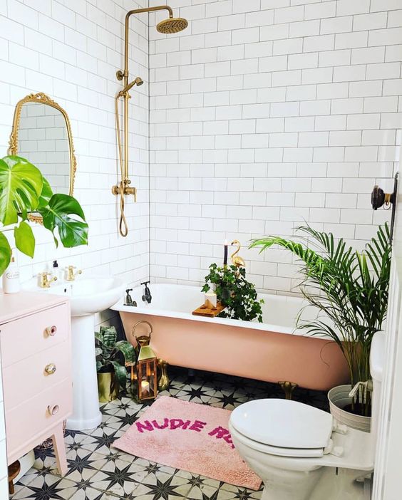 1-a-glam-tropical-bathroom-in-neutrals-a-pink-tub-a-pale-pink-vanity-a-pink-rug-and-potted-plants-gold-touches