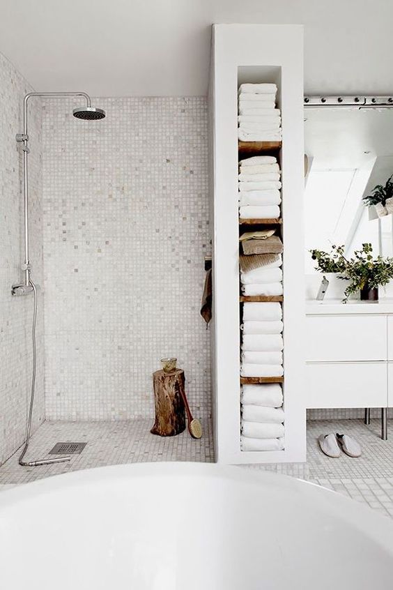 17-a-built-in-shelving-unit-that-doubles-as-a-shower-space-divider-and-holds-all-the-towels-is-a-smart-solution