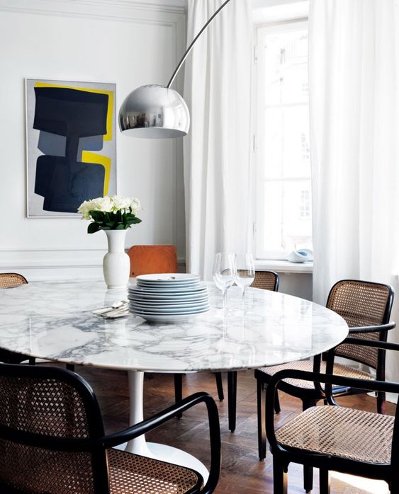 22-a-chic-white-marble-round-dining-table-and-rattan-and-cane-chairs-make-up-a-chic-mid-century-modern-dining-zone