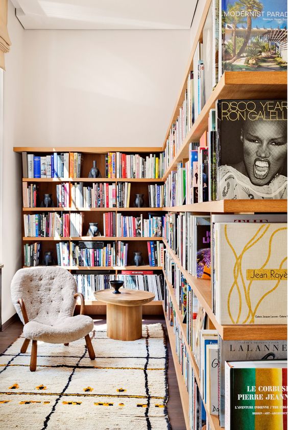 A-modern-home-office-with-a-large-l-shaped-floating-shelving-unit-that-doubles-as-a-space-divider-and-modern-furniture
