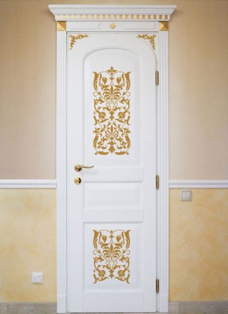 A-white-door-with-gold-ornate-stencils-and-a-gold-handle-looks-very-chic-and-very-stylish