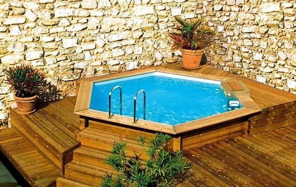 Above-ground-pools-with-decks-small-garden-pool-stone-wall-wooden-deck