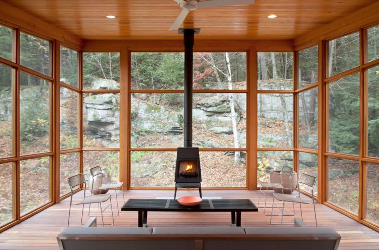 Super-cozy-sunroom-filled-with-natural-wood-and-a-wood-burning-stove-750x495-1