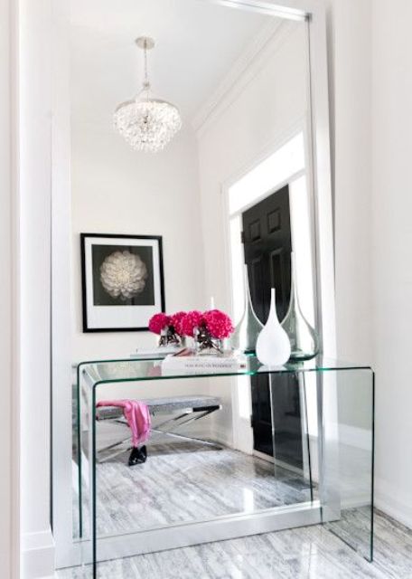 06-a-modern-mirror-with-no-frame-takes-the-whole-wall-and-a-glass-console-complements-the-look