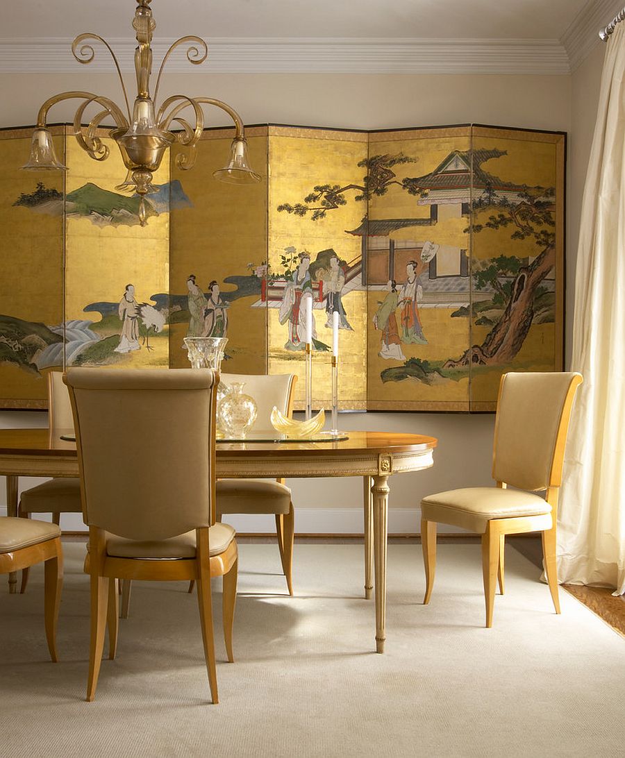Chinese-decorative-screen-in-gold-creates-a-dramatic-backdrop-for-the-dining-room-in-gold
