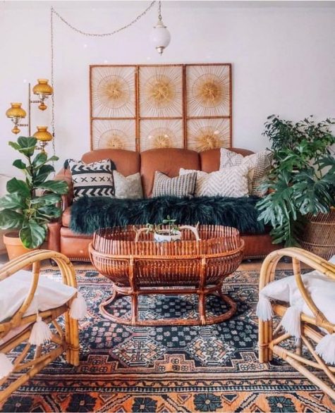 A-bright-moroccan-living-room-with-a-rust-leather-sofa-rattan-chairs-potted-plants-and-moroccan-lamps