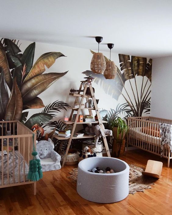 A-jungle-themed-nursery-with-a-printed-leaf-wall-rattan-lamps-an-elephant-chair-and-a-jute-rug