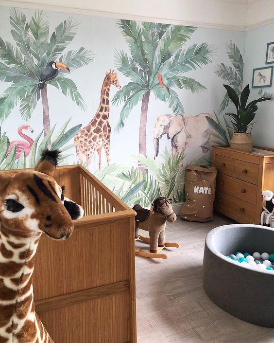 A-jungle-themed-nursery-with-a-statement-animal-wall-animal-toys-potted-plants-and-cute-furniture