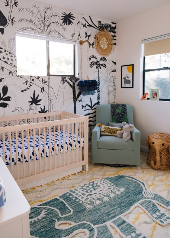 A-modern-boho-jungle-nursery-with-a-statement-black-and-white-wall-layered-rugs-animal-toys-and-bright-furniture