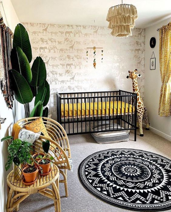 A-super-bold-safari-nursery-with-an-animal-print-wall-a-black-crib-with-mustard-bedding-a-tassel-chandelier-rattan-furniture-and-potted-plants-plus-a-printed-rug