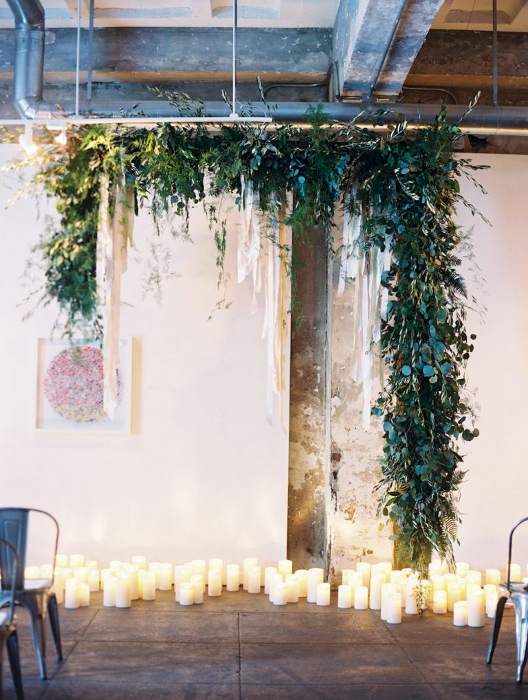 Industrial-chic-hanging-greenery-garland-wedding-backdrop-with-candles-768x1019-1