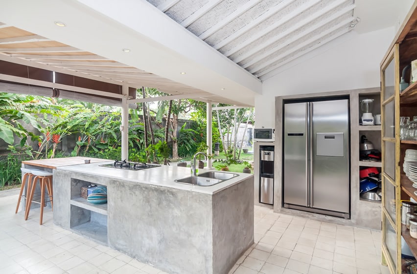 Outdoor-kitchen-with-concrete-counter-stainless-fridge