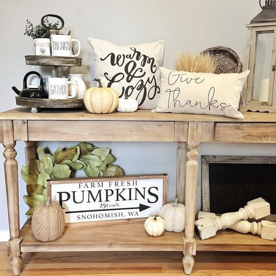 02-a-neutral-fall-console-table-with-white-natural-and-faux-pumpkins-wheat-leaves-and-printed-pillows