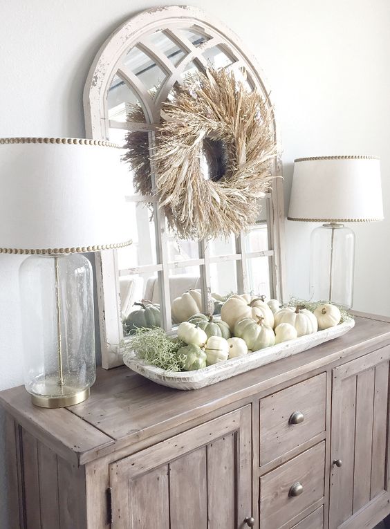 03-a-farmhouse-buffet-with-a-corn-husk-wreath-over-the-table-and-a-tray-with-white-and-green-pumpkins-plus-moss